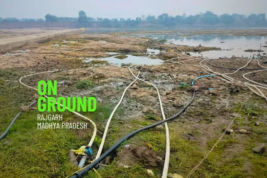 Farmers drawing water for irrigation from nearby pond in Rajgarh