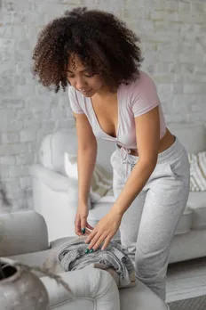 black woman doing housework in stylish apartment