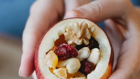 crop chef showing delicious filled apple at home