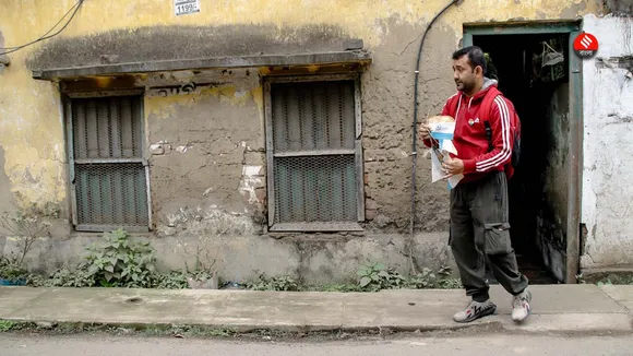 Flagman Priyanjan Sarkar carefully kept the tricolour lying on road with himself