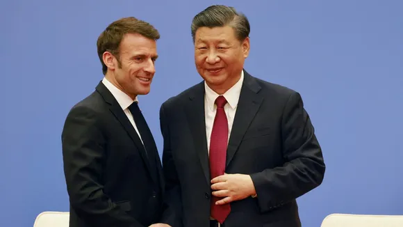 French President Emmanuel Macron and Chinese President Xi Jinping shake hands at a Franco-Chinese business council meeting in Beijing, China, April 6, 2023. (Reuters)