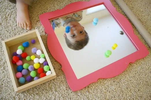 Toddler Activities: Play with Pompoms, Cardboard Tube and a Mirror - Buggy  and Buddy