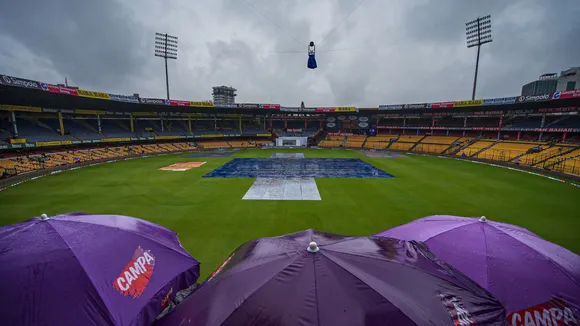 The pitch covered during rains on the first day of the first test cricket match between India and New Zealand at M Chinnaswamy Stadium, in Bengaluru, Wednesday, Oct 16, 2024.