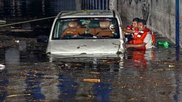Rescue operation underway after a car got stuck in a waterlogged underpass following heavy rain, in Bengaluru.