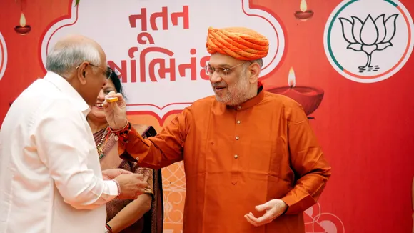 Union Home Minister and BJP leader Amit Shah offers sweets to Gujarat Chief Minister Bhupendra Patel during a gathering at his residence on the occasion of Gujarati New Year, in Ahmedabad, Saturday, Nov. 2, 2024.