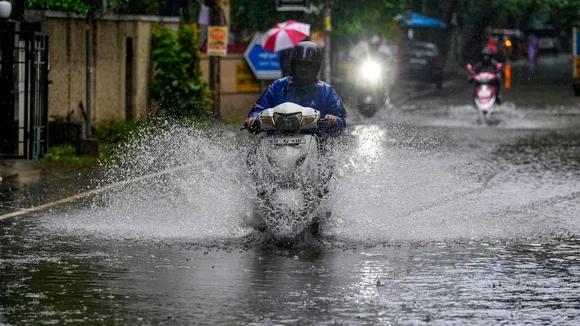 A commuter on a waterlogged road amid heavy rain owing to Cyclone Fengal, in Chennai, Saturday, Nov. 30, 2024.