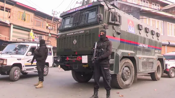 Security personnel stand guard on a road amid a joint operation by Indian Army & J&K Police, in Srinagar, Tuesday, Dec. 3, 2024.