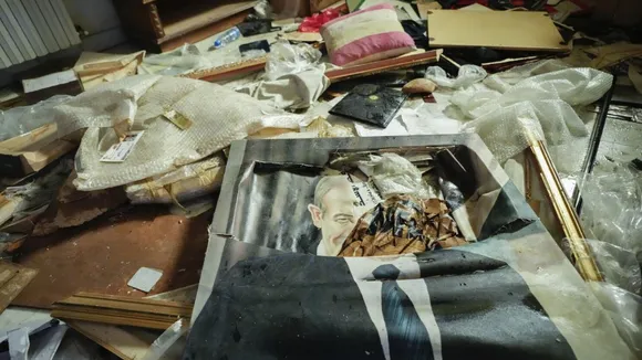 A broken portrait of late Syrian President Hafez Assad lies on the floor