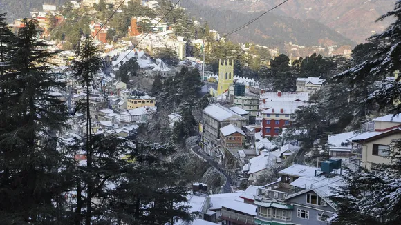 Snow covered houses and buildings after fresh snowfall in Shimla, Himachal Pradesh, Monday, Dec. 9, 2024
