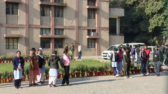 Officials with a sniffer dog inspect the premises of the Cambridge School at Shri Niwas Puri after it received bomb threat over email, in New Delhi, Friday, Dec. 13, 2024.