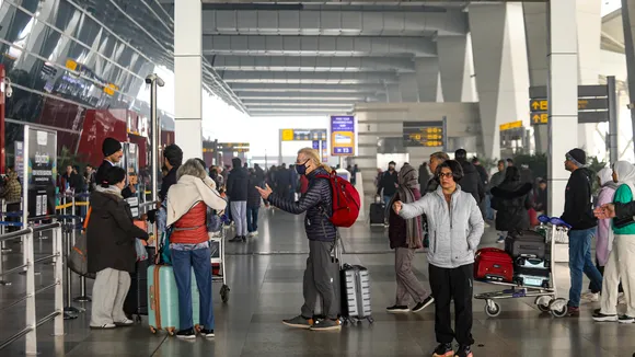 Passengers at Indira Gandhi International Airport during a cold and foggy winter morning, in New Delhi, Saturday, Jan. 4, 2025