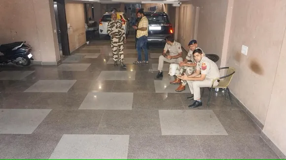 Security personnel guard during raids by Delhi Police's Special Cell on the premises of NewsClick at Saket, in New Delhi