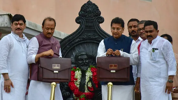 Maharashtra Deputy Chief Minister Ajit Pawar and state Minister Deepak Kesarkar show 2024-25 state Budget bags during the Monsoon Assembly session, at Vidhan Bhavan, in Mumbai, Friday, June 28, 2024.