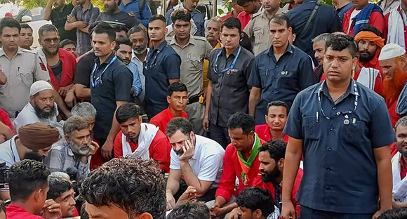 Rahul Gandhi interacts with porters at Anand Vihar railway station