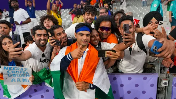Silver medallist India's Neeraj Chopra with fans after the men's javelin throw final at the 2024 Summer Olympics, in Paris, France, Thursday, Aug. 8, 2024.