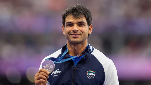 Silver medalist India's Neeraj Chopra poses for photos at the podium during the victory ceremony for the men's javelin throw final event at the 2024 Summer Olympics, in Paris, France, Friday, Aug. 9, 2024.