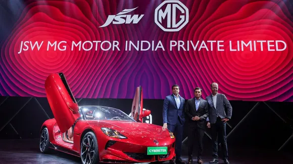 JSW Cement managing director Parth Jindal, JSW Steel MD Sajjan Jindal, and Rajeev Chaba, CEO Emeritus of MG Motor India, with the MG Cyberster, an electric sports car, in Mumbai. (Reuters)