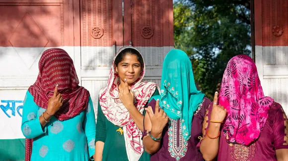 Voters wait in a queue to cast their votes at a polling station at Ghasera village during the Haryana Assembly elections, in Nuh district, Saturday, Oct. 5, 2024.