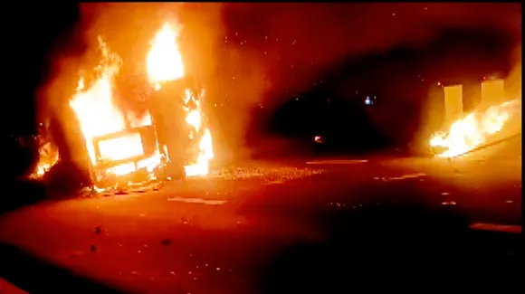 A passenger bus in flames after it overturned, on the Samruddhi Expressway