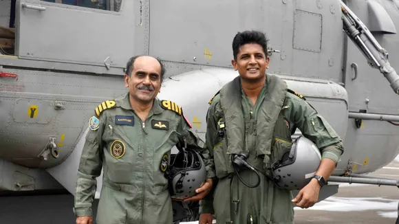 Navy pilot Lt Commander Nikhil Aher with his Sainik School senior Capt Kaustubh Gosavi near a Kamov Ka-31 helicopter. Aher flew Gosavi in the latter's last sortie a day before Capt Gosavi retired on July 31.