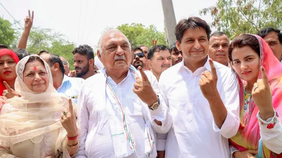 Congress leaders Bhupinder Singh Hooda and Deepender Singh Hooda after casting their votes at a polling booth during the sixth phase of Lok Sabha elections, in Rohtak, Saturday, May 25, 2024