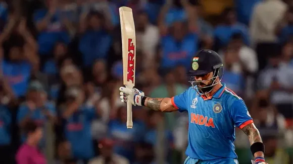 Virat Kohli celebrates his half century during the ICC Men's Cricket World Cup 2023 match between India and Bangladesh, at Maharashtra Cricket Association Stadium, in Pune, Thursday, Oct. 19, 2023.