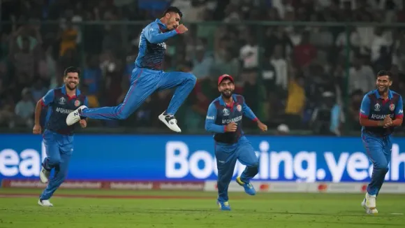 Afghanistan's Mujeeb Ur Rahman with teamamtes celebrates the wicket of England's Chris Woakes during the ICC Men's Cricket World Cup 2023 match between Afghanistan and England, at Arun Jaitley Stadium in New Delhi, Sunday, Oct. 15, 2023.