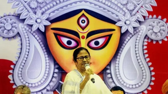 What is the political significance of Mamata Banerjee's hiked Puja doles amid growing corruption row