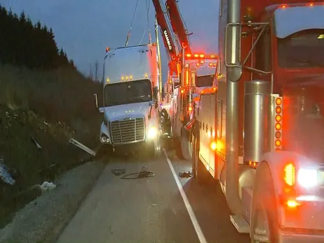 Tow truck driver injured removing tractor-trailer from ditch.