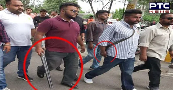 Youth Congress workers carry weapons during protest against fuel prices hike