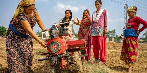 women with farming equipment