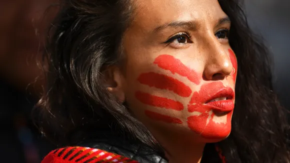Why Are Native American Women Painting Red Handprints On Their Mouth?