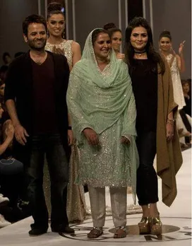 Pakistan's gang rape victim Mukhtar Mai walks on to stage during a fashion show in Karachi, Pakistan