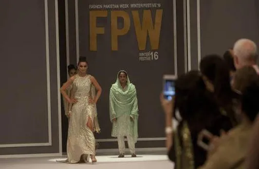 Pakistan's gang rape victim Mukhtar Mai walks on to stage during a fashion show in Karachi, Pakistan