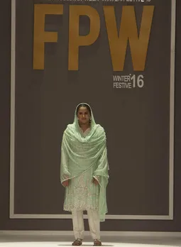 Pakistan's gang rape victim Mukhtar Mai walks on to stage during a fashion show in Karachi, Pakistan