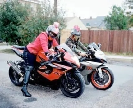 Women riding motorbike.