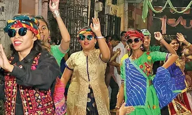 Garba enthusiasts in Vadodara play garba with umbrellas amid showers