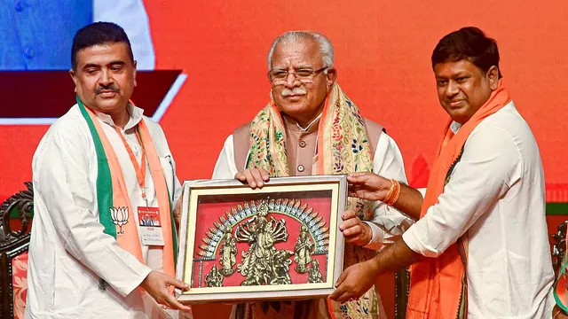 Union Power Minister Manohar Lal Khattar (C) receives a memento from Leader of Opposition in West Bengal Assembly Suvendu Adhikari (L) and Union Minister of State for Education Sukanta Majumder (R) during BJP's Extended State Organisational Meeting, in Kolkata,Wednesday, July 17, 2024.