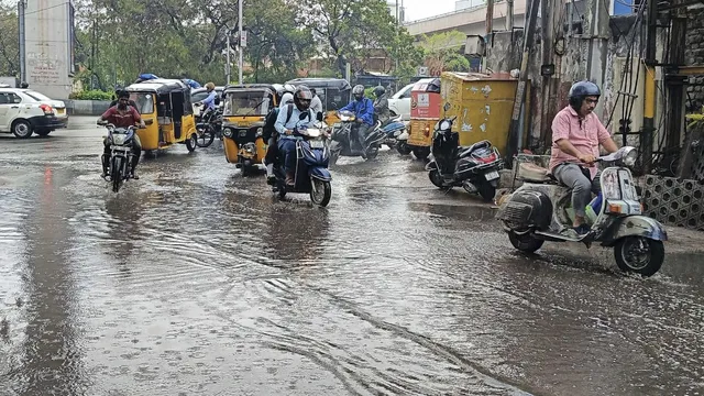 Commuters on the road after rains lashed Malakpet areas, in Hyderabad, Saturday morning, April 20, 2024.