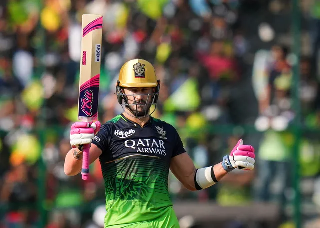 Royal Challengers Bangalore batter Faf du Plessis raises his bat to celebrate his fifty during the IPL 2023 cricket match