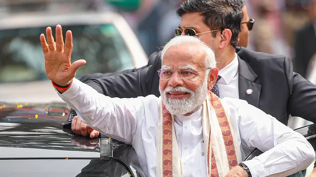 Prime Minister Narendra Modi waves at people gathered for his welcome upon his arrival at Thriprayar, in Thrissur district