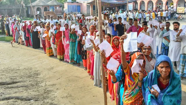 People wait in queues to cast their votes at a polling booth during the sixth phase of Lok Sabha elections, at Patahi in Muzaffarpur district, Saturday, May 25, 2024