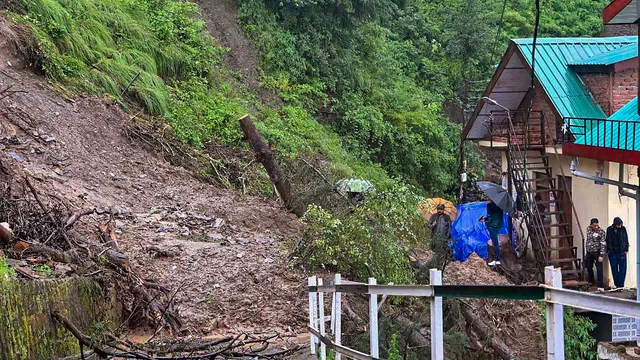 Debris on a road after landslide near a residential colony following monsoon rainfall, at Sanjauli in Shimla