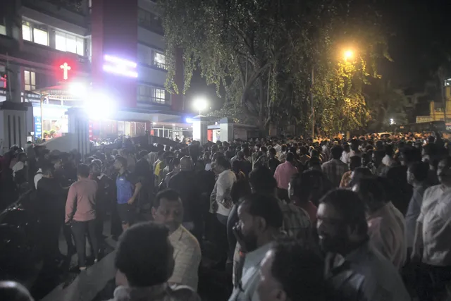 People gather outside the hospital where Shiv Sena (UBT) leader Vinod Ghosalkar's son Abhishek was brought, in Mumbai, Thursday, Feb. 8, 2024. Abhishek was shot dead during a Facebook live by local social activist Mauris Noronha, who also ended his life by shooting self, according to police.