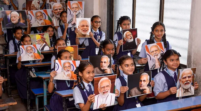 Students show portraits of Prime Minister Narendra Modi as they celebrate his birthday, in Surat, Saturday, Sept. 16, 2023.