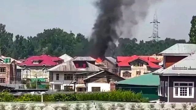 Smoke billows out from a building after an encounter broke out between security forces and militants, in Pulwama district, Monday, June 3, 2024