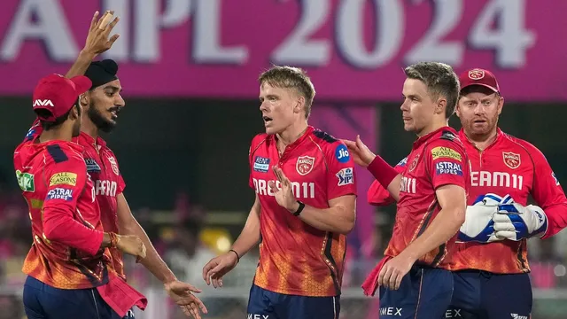 PBKS' Nathan Ellis celebrates with teammates after taking the wicket of RR captain Sanju Samson during an Indian Premier League (IPL) 2024 