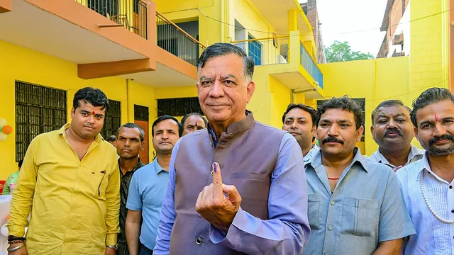 Uttar Pradesh Legislative Assembly Speaker Satish Mahana shows his finger marked with indelible ink after casting his vote for the fourth phase of Lok Sabha elections, in Akbarpur, Uttar Pradesh