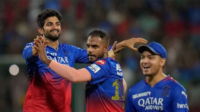 Royal Challengers Bengaluru's Yash Dayal celebrates with teammates after taking the wicket of Delhi Capitals' captain Axar Patel during an Indian Premier League (IPL) 2024 T20 cricket match