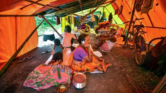 Residents of a flood affected area take refuge in a makeshift shelter, at Kaliabor, in Nagaon district, Saturday, July 13, 2024.
